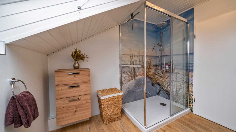 Bad Dachoase mit Dachschräge und Dusche mit bedruckten Wandpaneelen